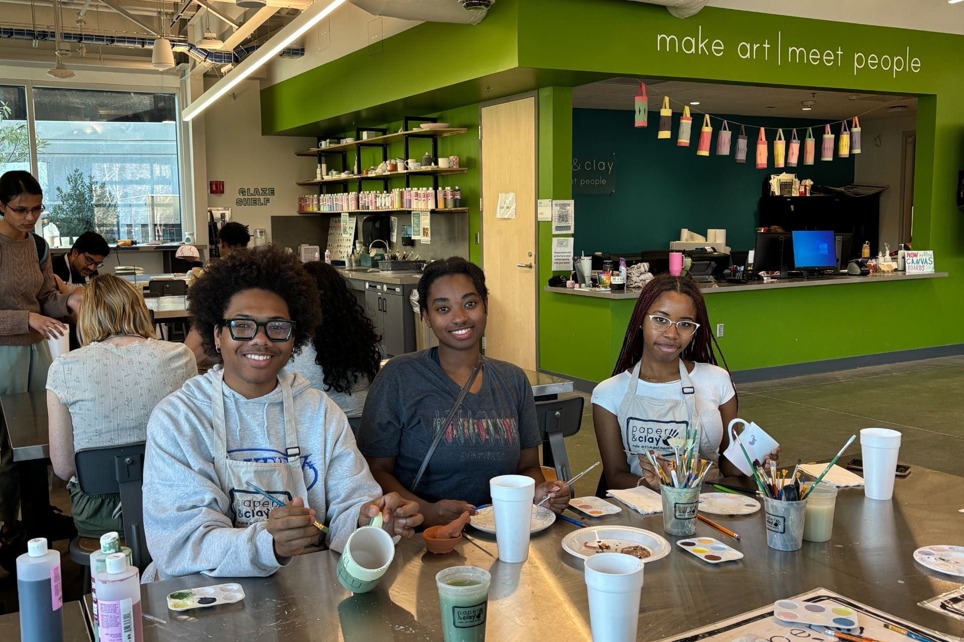 students working on art projects at Paper & Clay studio